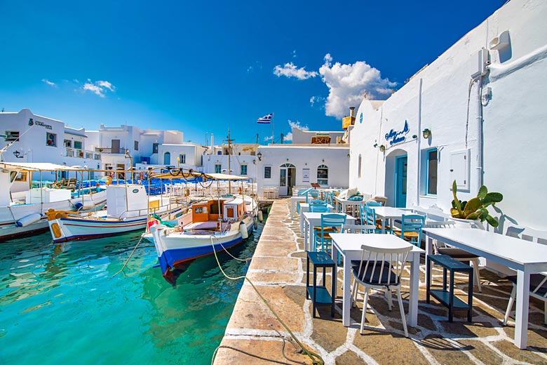 Admire colourful boats bobbing in Naoussa